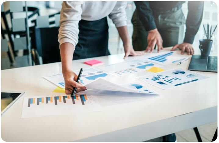 Consultants reviewing charts and contract documents